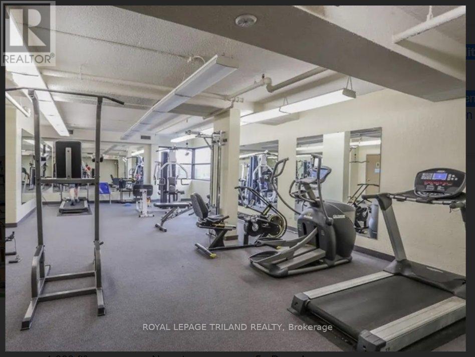 A gym with a variety of equipment including treadmills, weights, and exercise machines.
