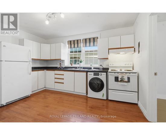 A white kitchen with a washing machine and a dishwasher.