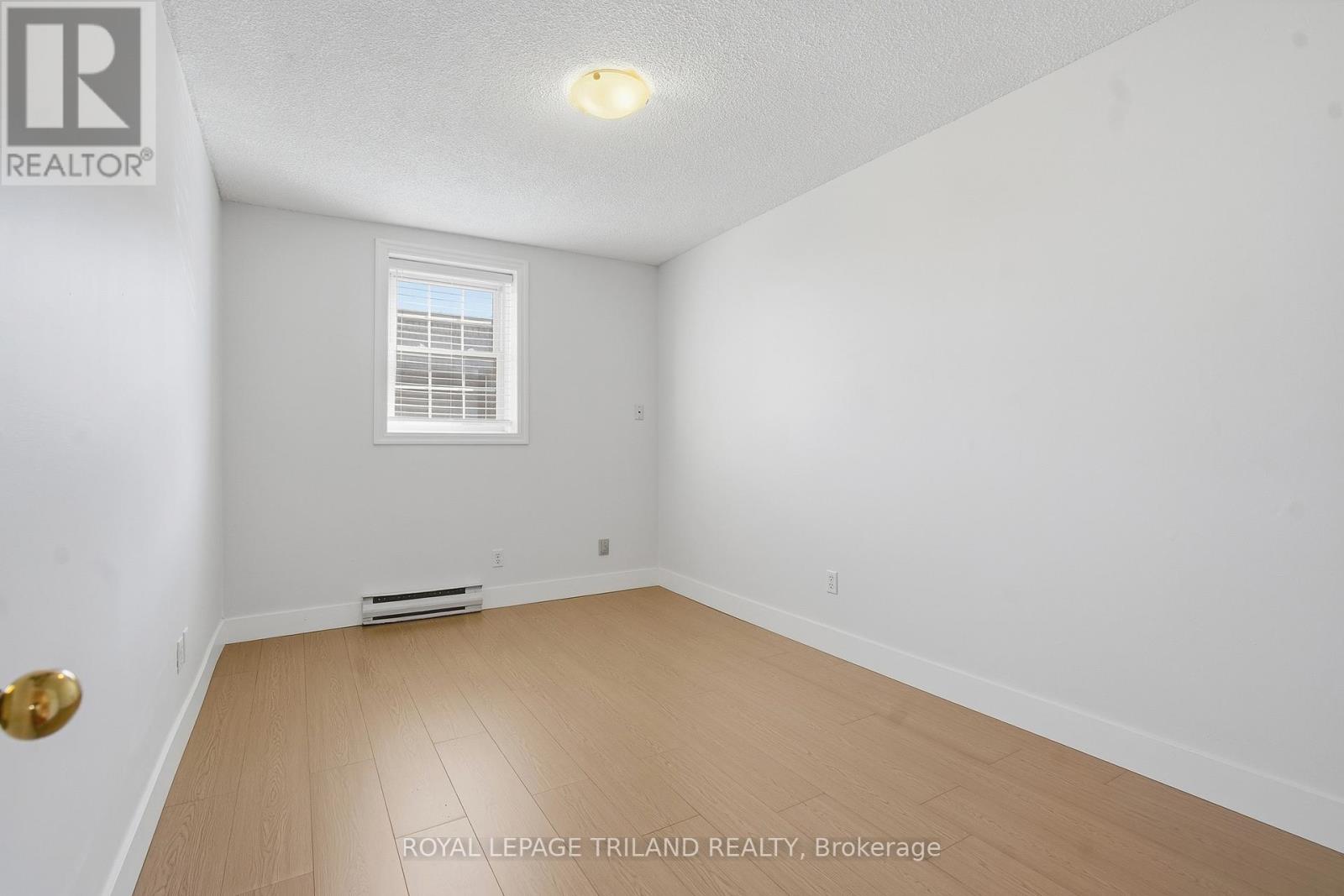 A white room with a window and a door.
