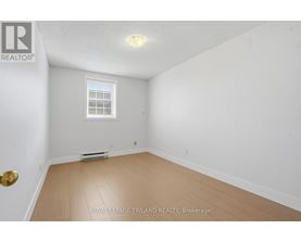 A white room with a window and a door.