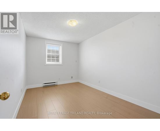 A white room with a window and a door.