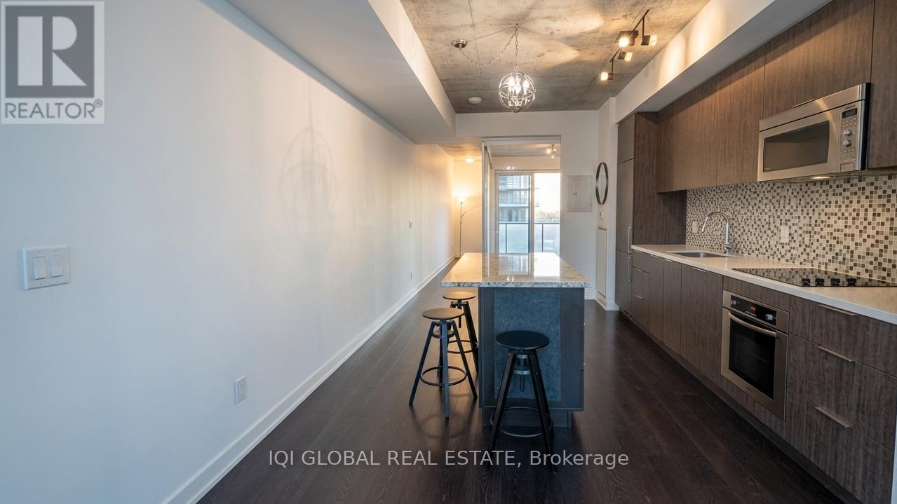 A kitchen with a bar stool in front of a counter.