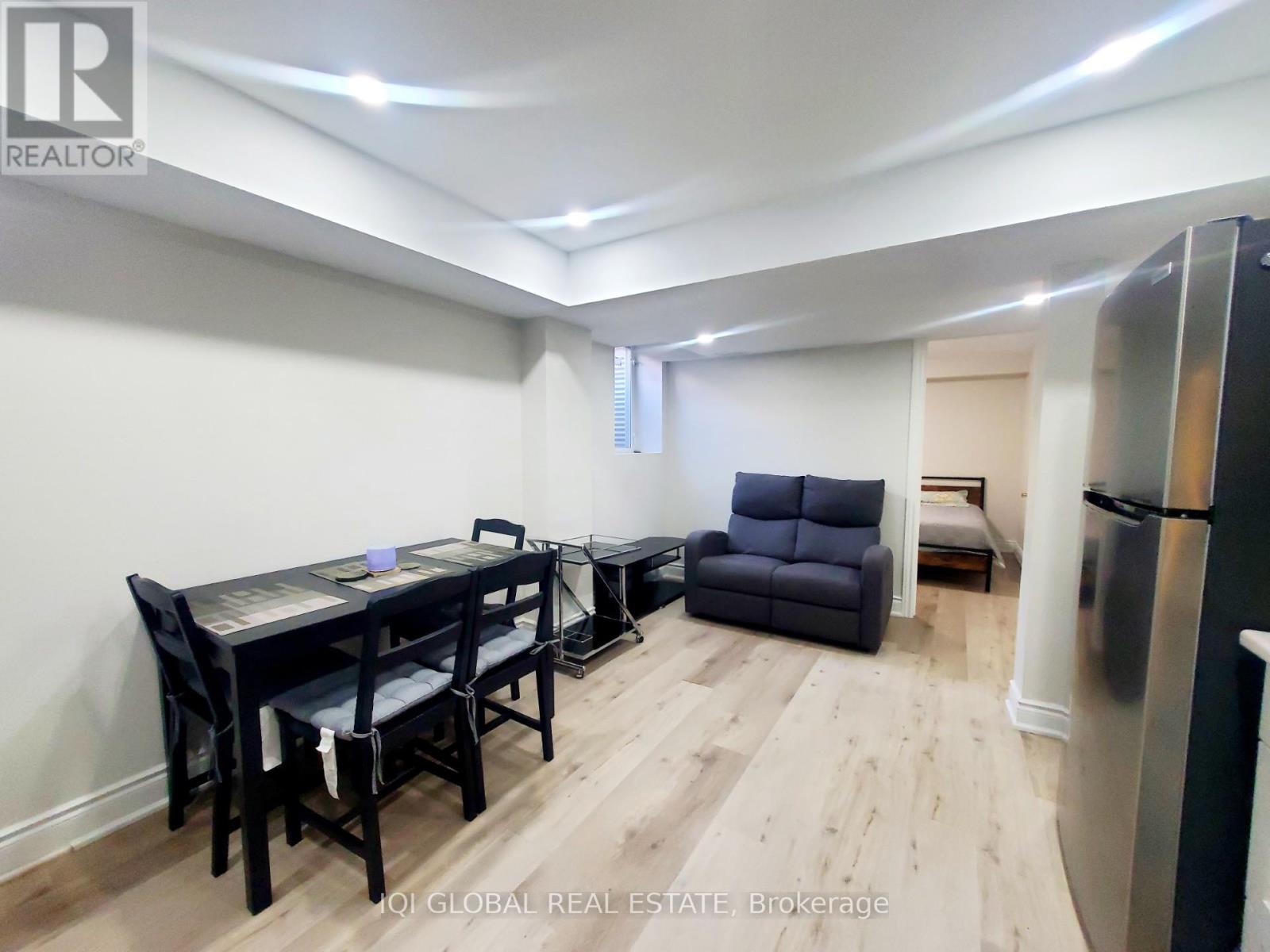 A dining room with a table and chairs.