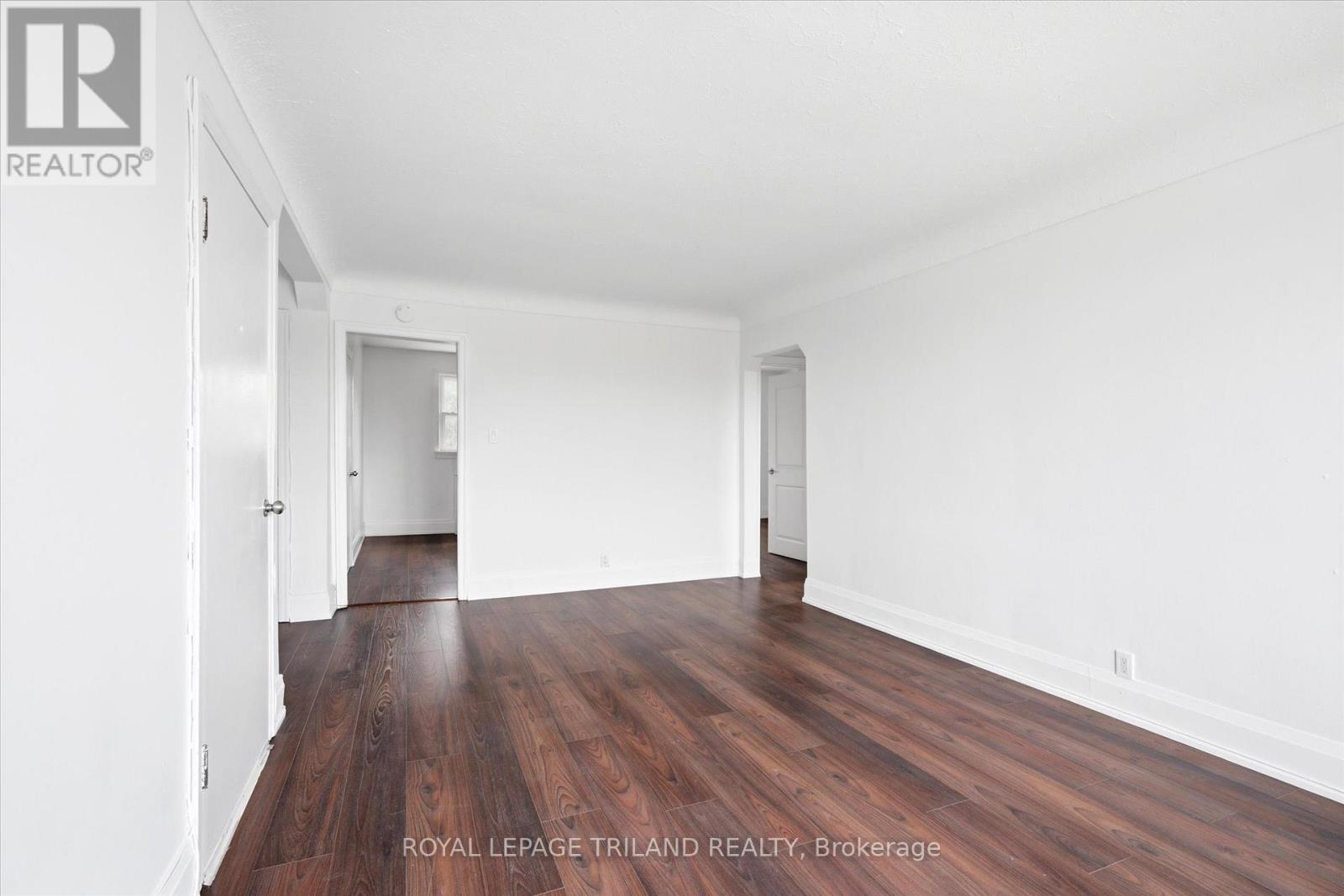 A room with wooden floors and white walls.
