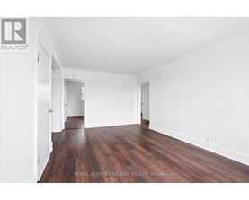 A room with wooden floors and white walls.