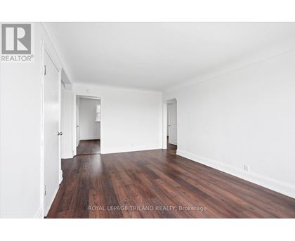 A room with wooden floors and white walls.