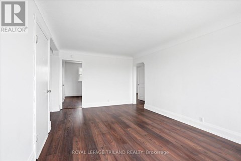 A room with wooden floors and white walls.