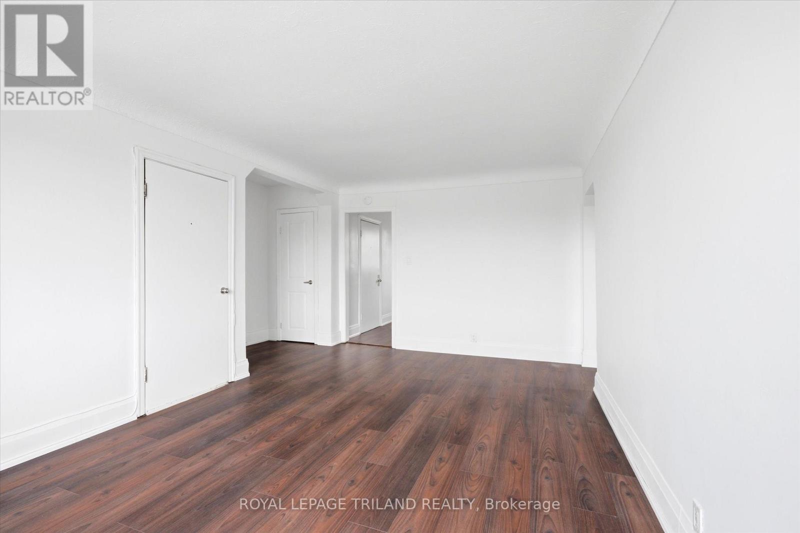 A room with wooden floors and white walls.