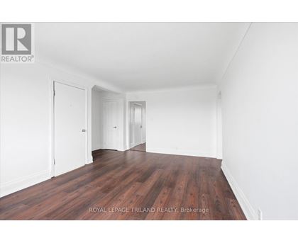 A room with wooden floors and white walls.