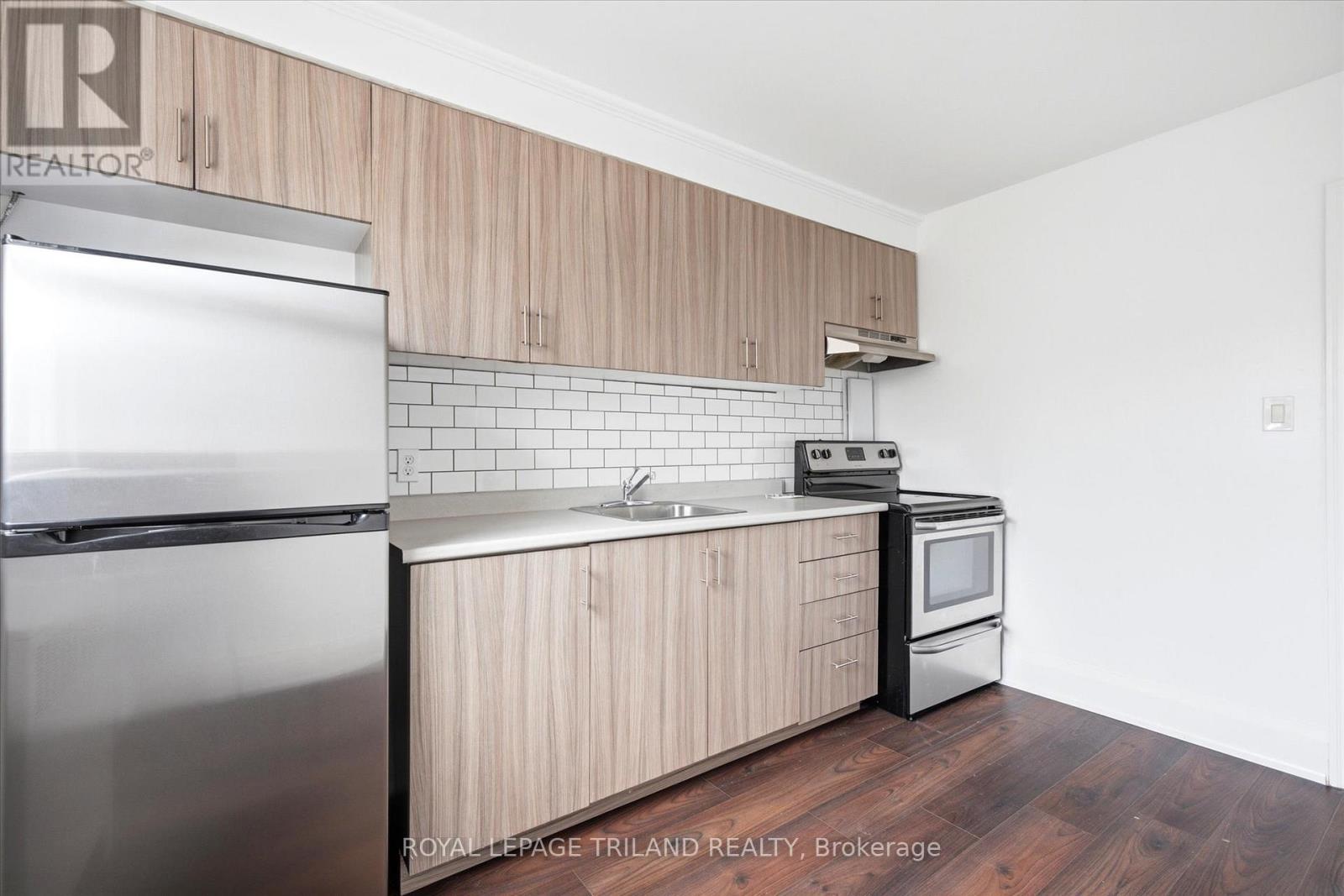 A kitchen with wooden cabinets and stainless steel appliances.