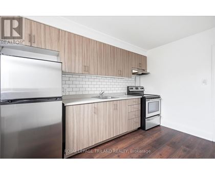 A kitchen with wooden cabinets and stainless steel appliances.