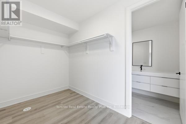 A white bedroom with a dresser and mirror.