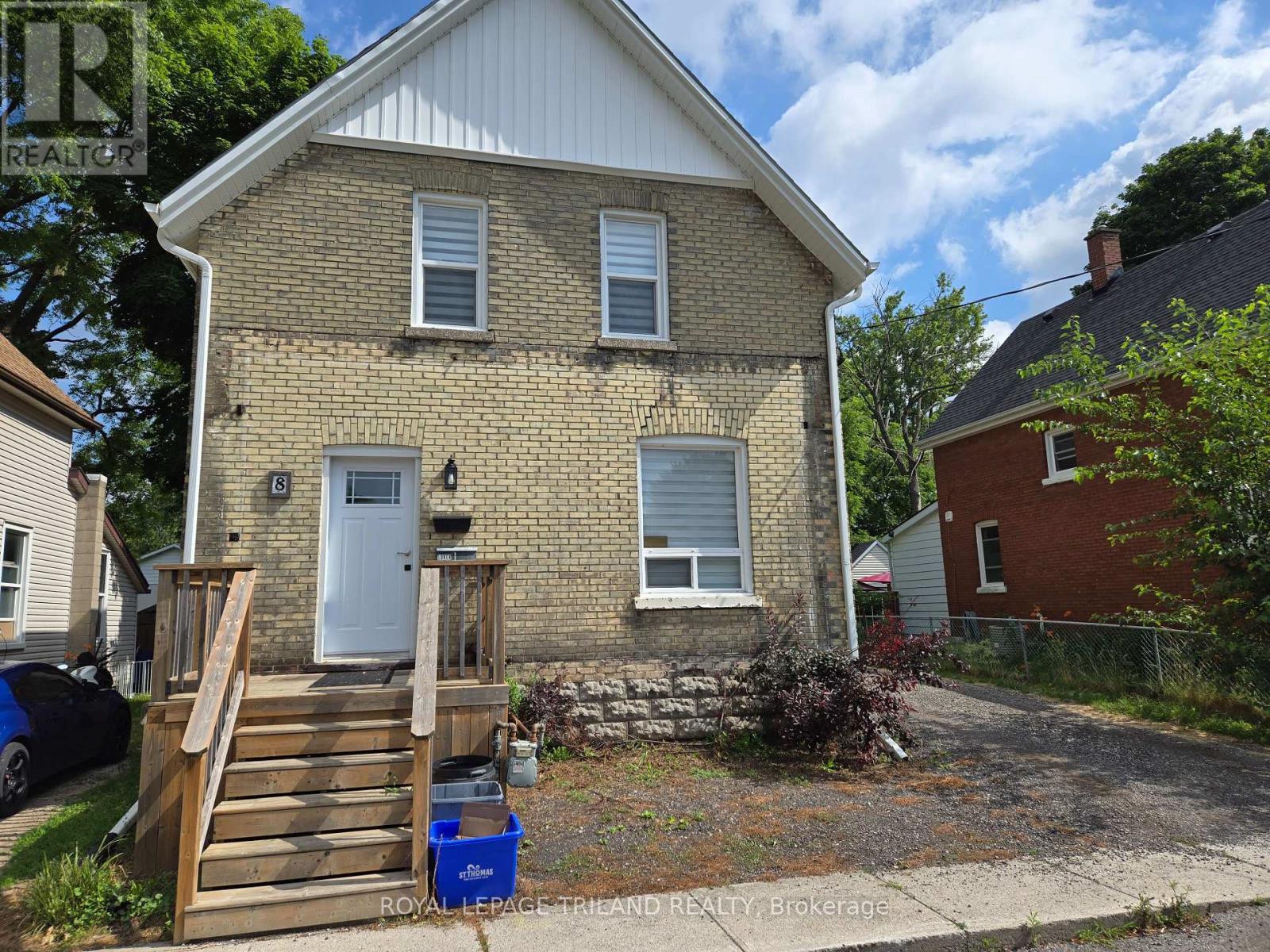 A house with a white door and windows is for sale.