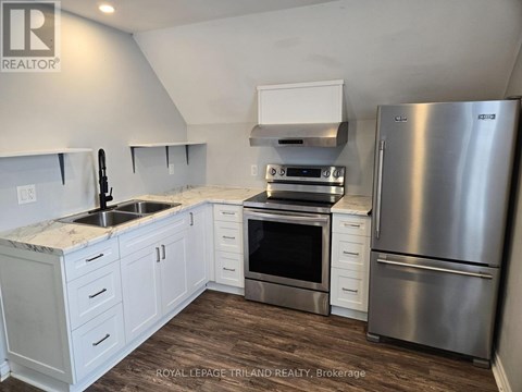 A kitchen with white cabinets and stainless steel appliances.
