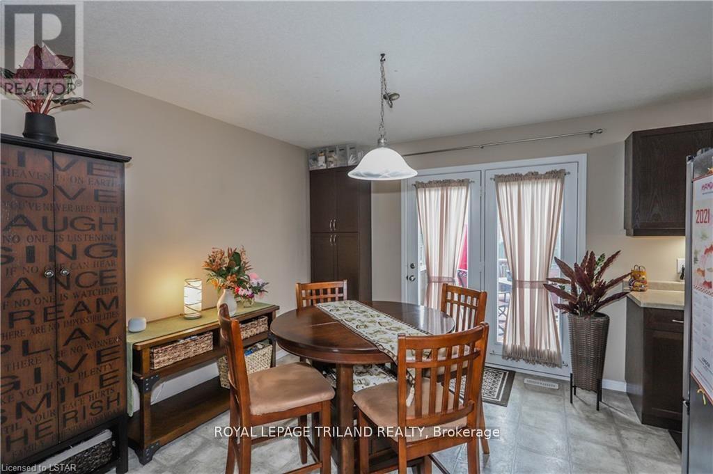 A dining room with a wooden table and chairs.
