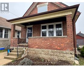A brick house with a small front yard.
