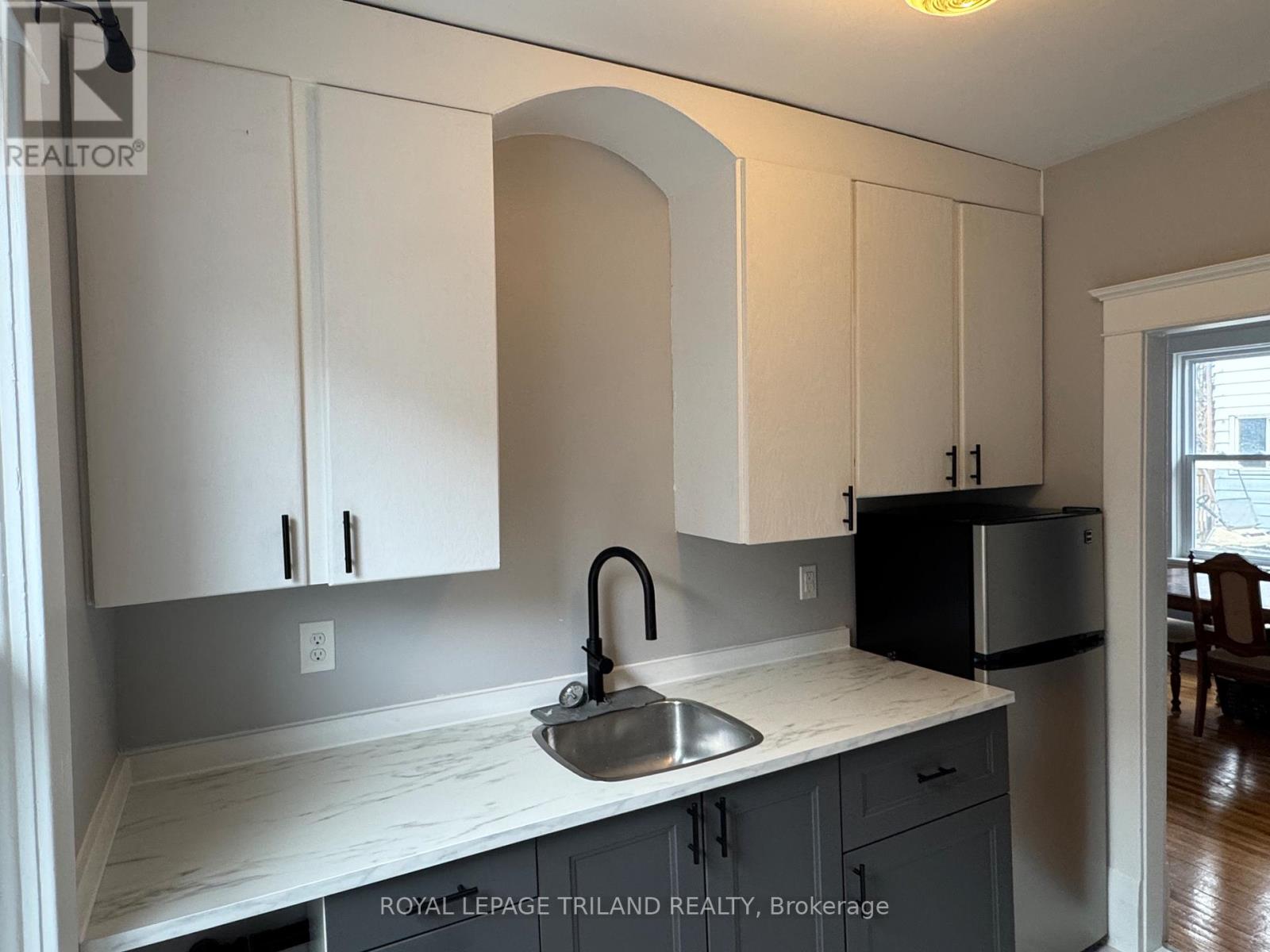 A kitchen with a sink and cabinets.