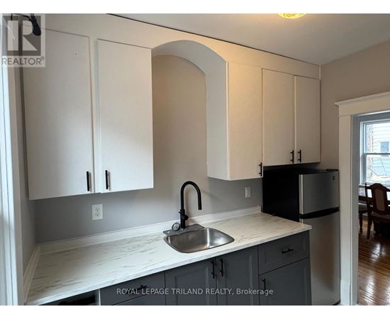 A kitchen with a sink and cabinets.