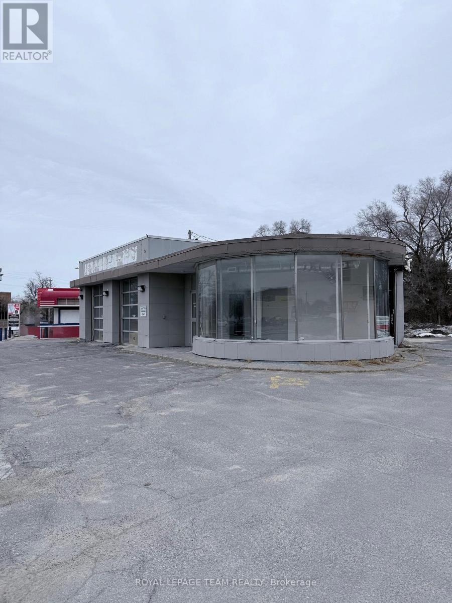 A grey building with a glass front and a sign that says "REALTOR" on it.