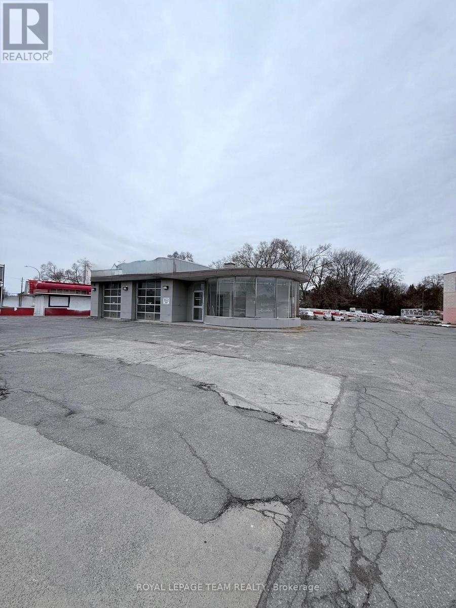 A large, empty parking lot with a building in the background.