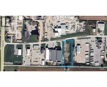 A satellite image shows a large building complex with a parking lot in front.