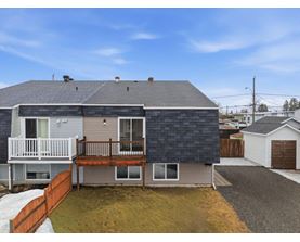 A house with a grey roof and a brown fence.