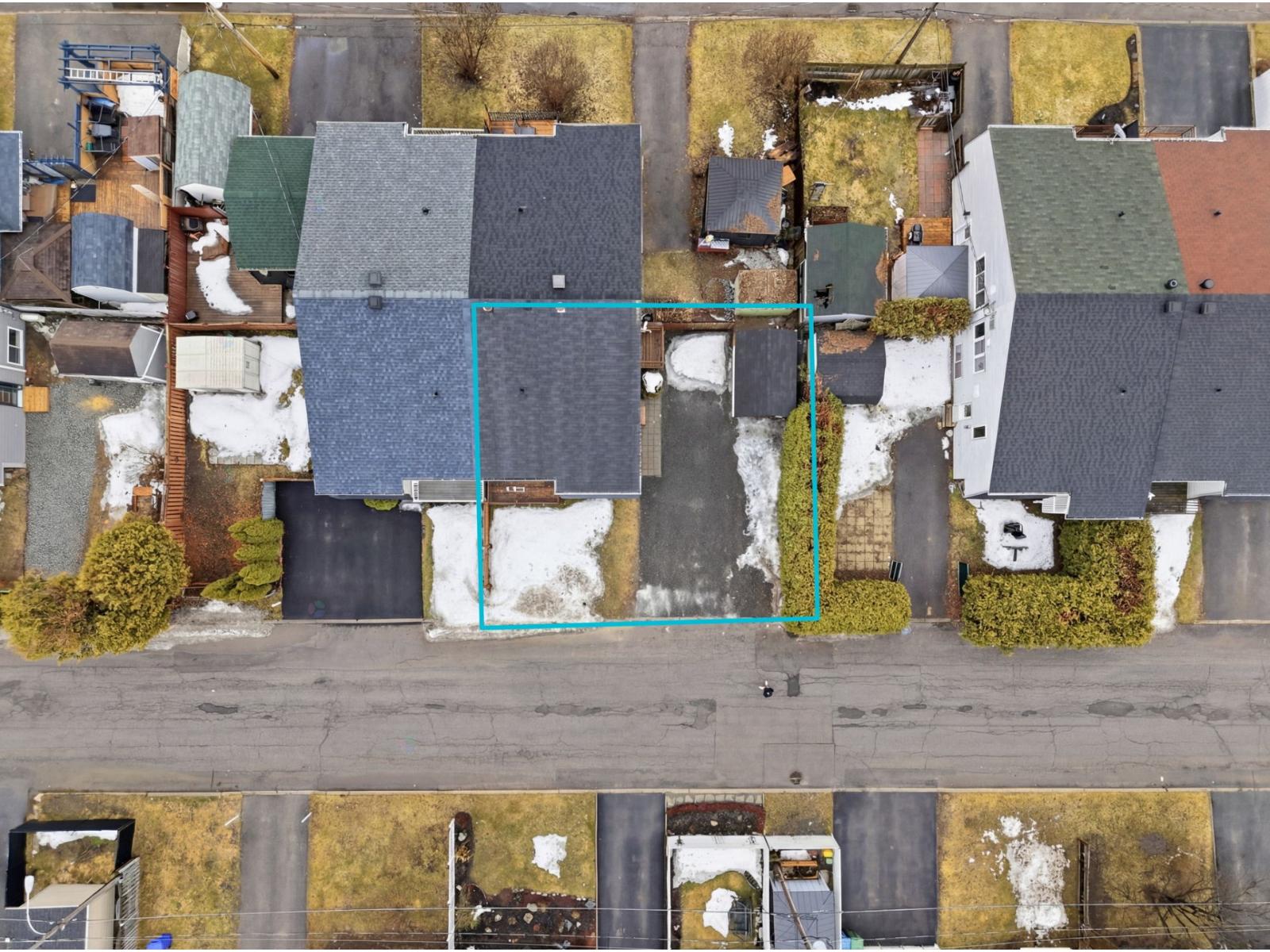 A bird's eye view of a residential area with a blue line running through the middle.
