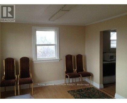 A room with four chairs and a window.