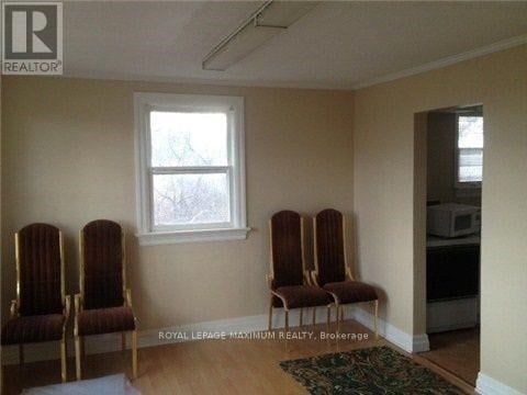 A room with four chairs and a window.