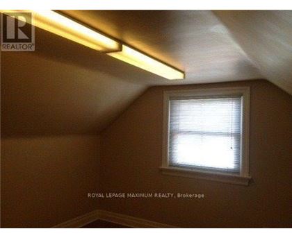 A room with a window and a light on the ceiling.
