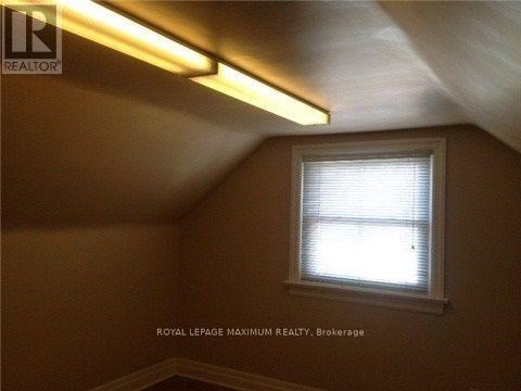 A room with a window and a light on the ceiling.