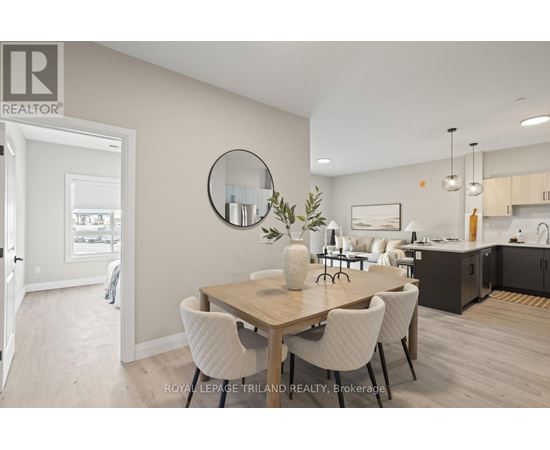 A dining room with a wooden table and white chairs.