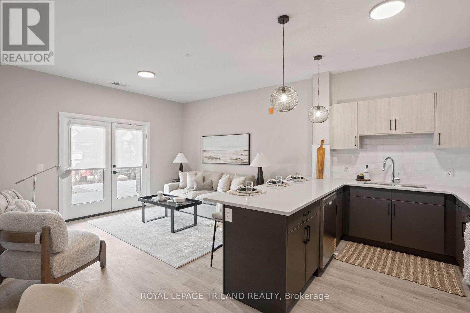 A modern kitchen and living room with a dining table and chairs.