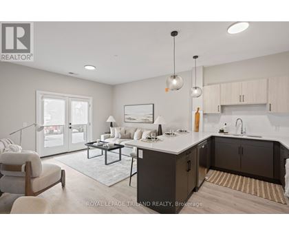 A modern kitchen and living room with a dining table and chairs.