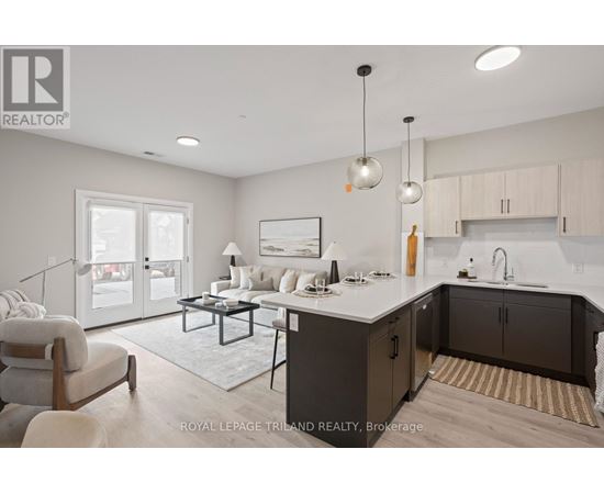 A modern kitchen and living room with a dining table and chairs.