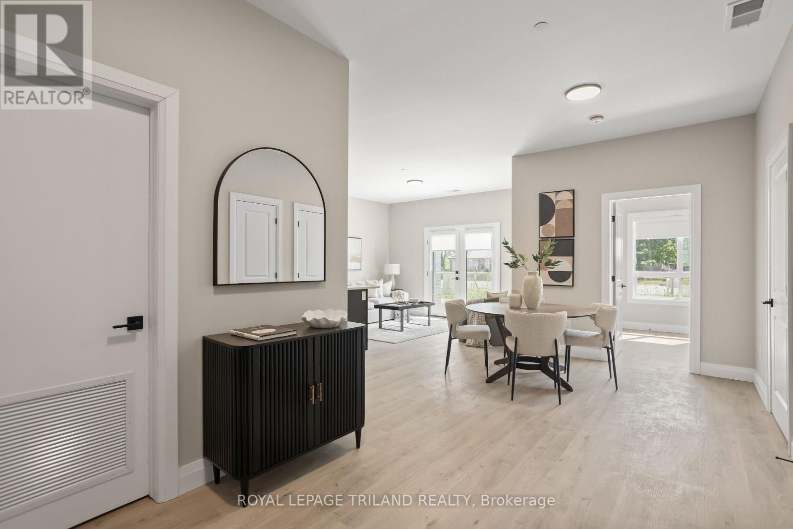 A well-lit, spacious room with a dining table and chairs.
