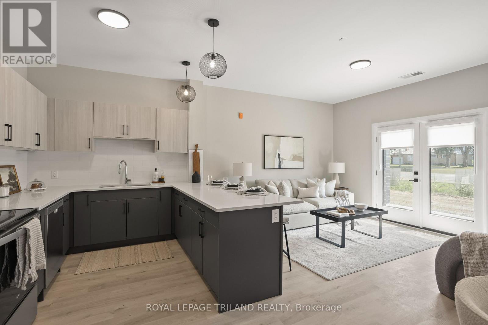 A modern kitchen with a large island and a dining area.