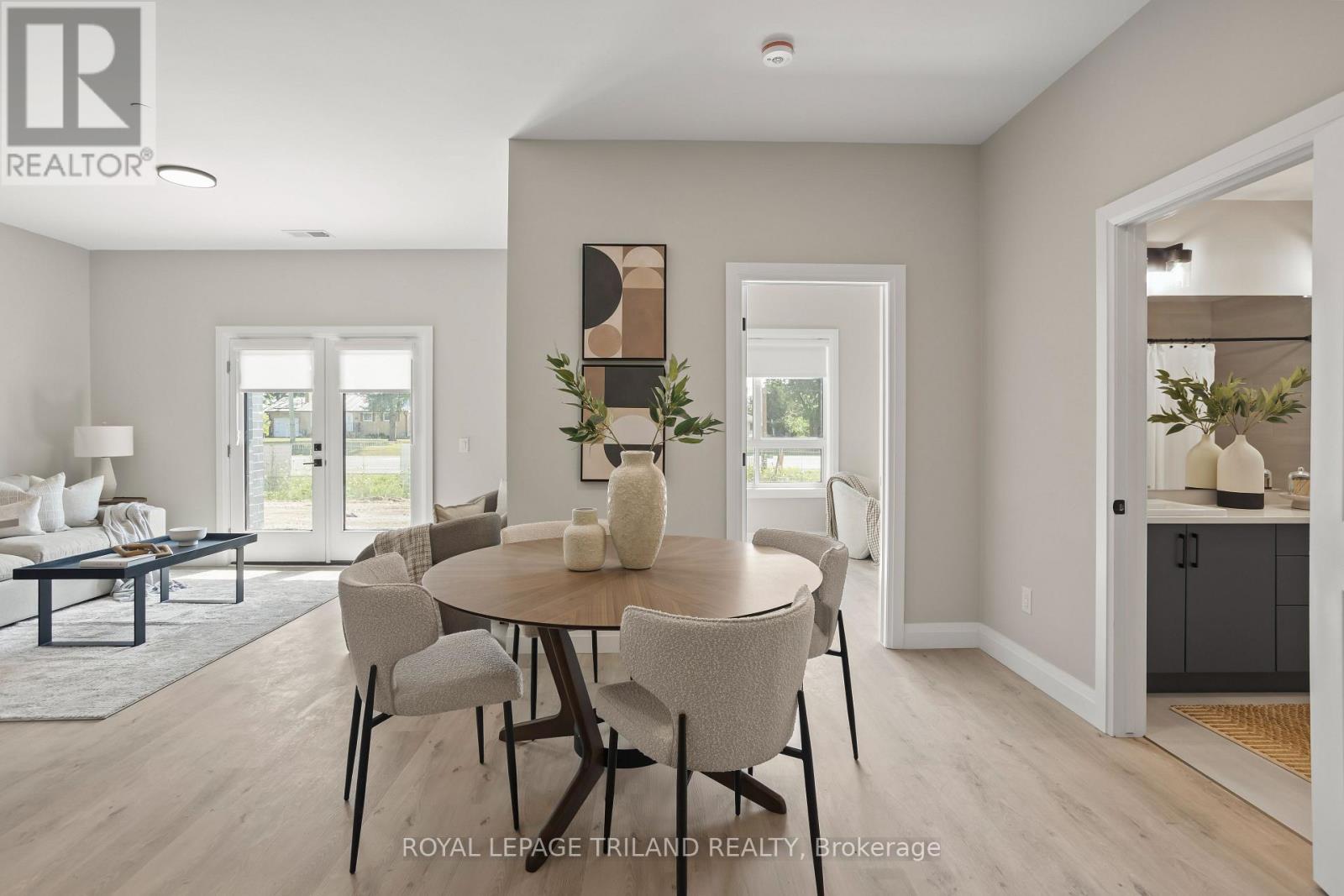 A dining room with a round table and chairs.