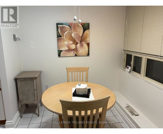 A living room with a brown couch, a wooden table, and a television.