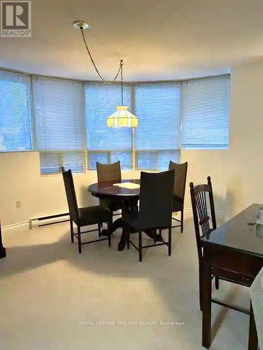 A dining room with a table and chairs.