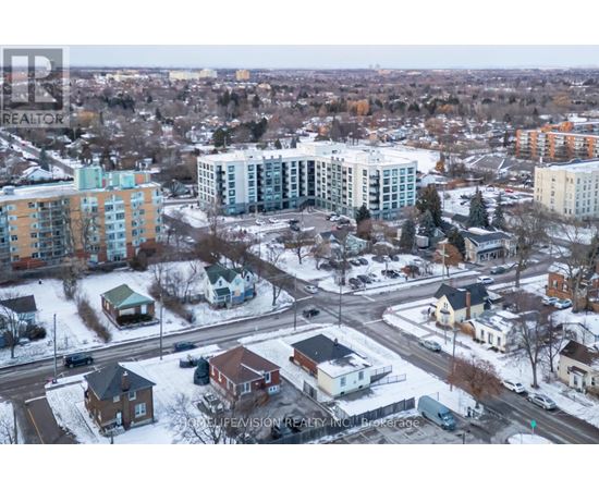 A winter scene of a residential area with houses and apartment buildings.