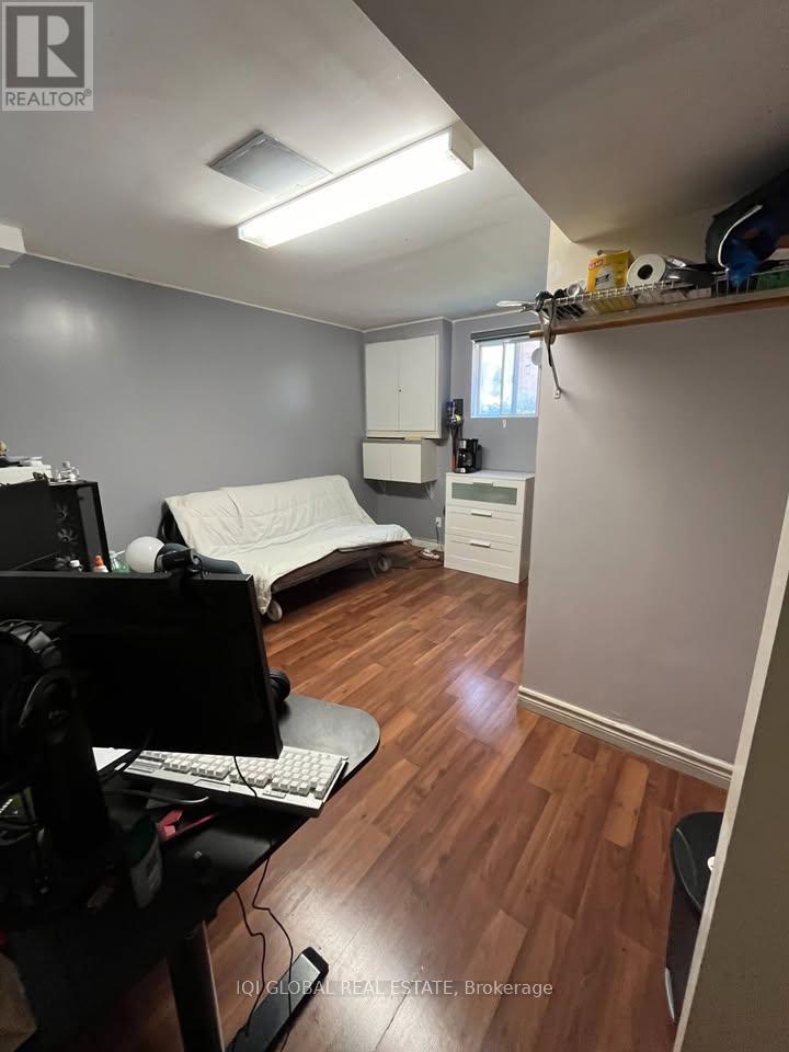 A room with a desk and a computer monitor.