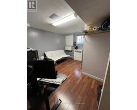 A room with a desk and a computer monitor.