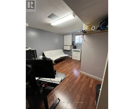 A room with a desk and a computer monitor.