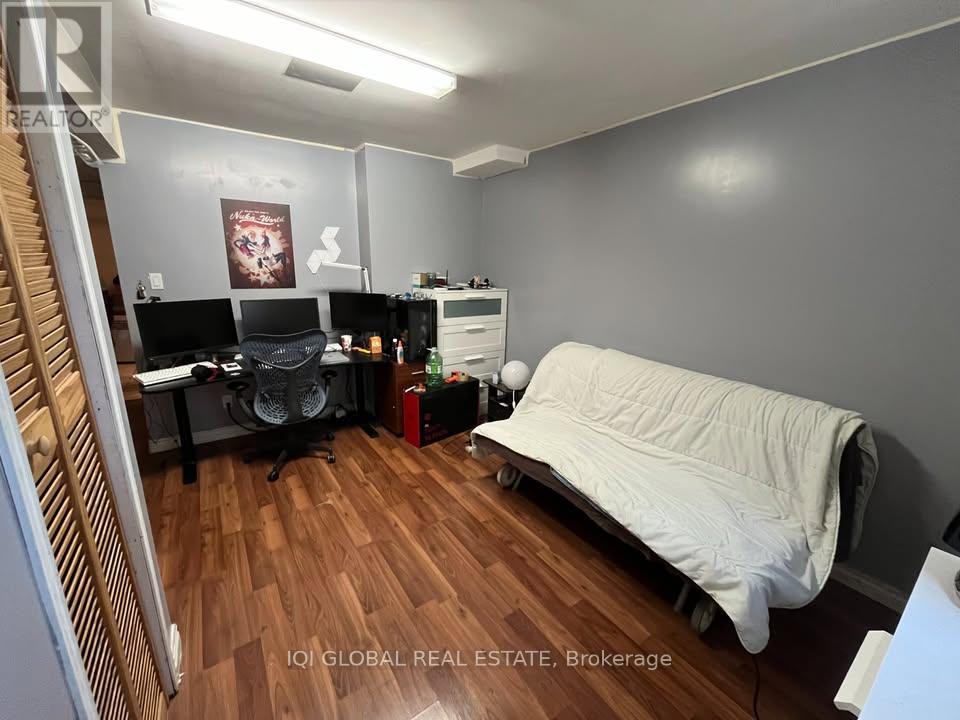 A room with a bed, desk, and chair.