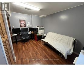 A room with a bed, desk, and chair.