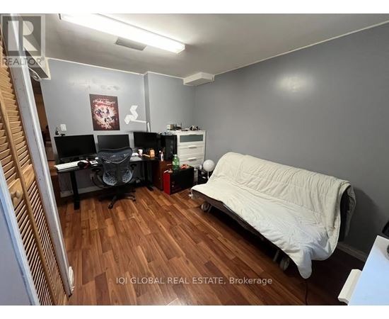 A room with a bed, desk, and chair.