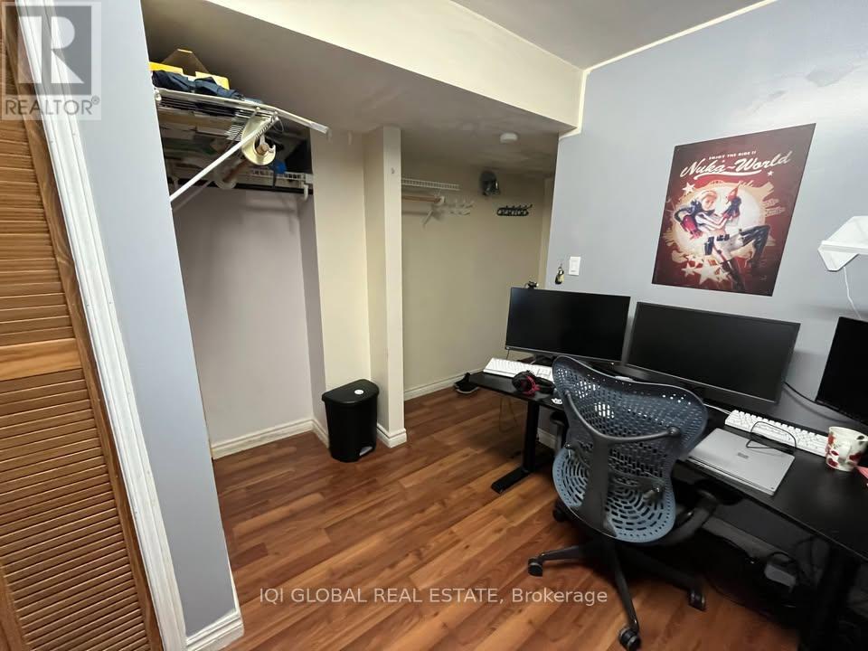 A brokerage office with a desk, chairs, and a poster on the wall.