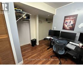 A brokerage office with a desk, chairs, and a poster on the wall.