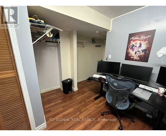 A brokerage office with a desk, chairs, and a poster on the wall.